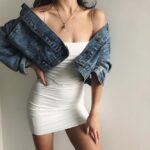 white Essential Square Neck Mini Dress (2) Women's white square neck mini dress styled with a blue denim jacket and delicate spaghetti straps.