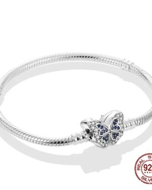 Silver snake chain charm bracelet featuring a butterfly shaped clasp decorated with sparkling clear and deep blue pavé stones.