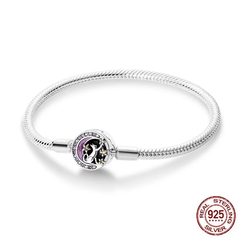 Silver snake chain charm bracelet featuring a round moon and stars clasp with purple and clear sparkling stone accents.