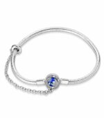 Silver Moon Star Charm Bracelet (1) Silver moon star charm bracelet with blue enamel crescent moon, sparkling star details, crystal accents, safety chain, and snake chain design.