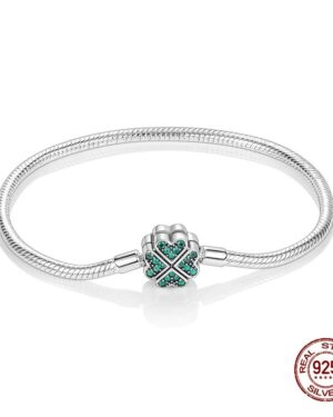 Silver snake chain charm bracelet featuring a four leaf clover clasp decorated with sparkling teal stones.