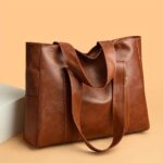 Avery Large Tote Bag-brown (5) Brown Avery Large Tote Bag shown with relaxed shoulder straps, spacious rectangular shape and textured finish