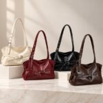 Bexley Belted Shoulder Bag collection in cream, burgundy, black and coffee brown with adjustable shoulder straps and buckle belt details