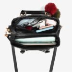 Camellia Pearl Charm Handbag-black (3) Open black Camellia Pearl Charm handbag showing spacious zipped compartments with room for everyday essentials and a tablet
