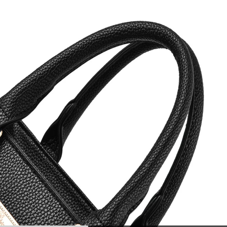 Close-up of black Camellia Pearl Charm handbag double top handles showing the textured finish and stitching