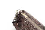 Cobra Snake Print Bucket Bag-Brown (7) Close-up of brown Cobra Snake Print bucket bag showing gold tone top zip closure, handle attachment and textured snakeskin finish