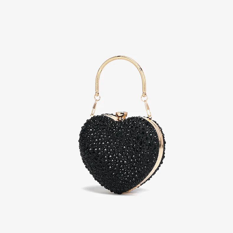Angled view of black rhinestone heart clutch bag with sparkling crystals, gold frame and metal top handle