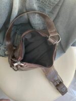 Open brown Dalton Retro Buckle Shoulder Bag showing zip-top closure, dark fabric lining and spacious main compartment