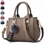 Taupe Darling Pom Pom handbag with double top handles, detachable shoulder strap, woven detailing and fluffy pom pom charm