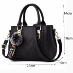 Black Darling Pom Pom handbag size guide showing 23 cm width, 19 cm height, 14 cm depth and 14 cm handle drop