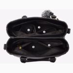 Interior view of black Darling Pom Pom handbag showing multiple compartments and zipped storage pockets