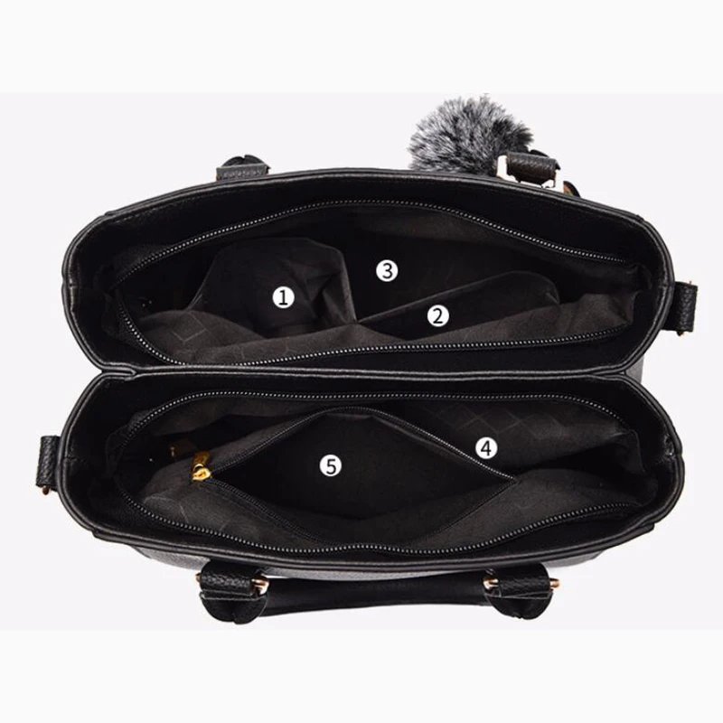 Interior view of black Darling Pom Pom handbag showing multiple compartments and zipped storage pockets