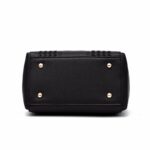 Bottom view of black Darling Pom Pom handbag showing structured base and four protective gold tone metal feet