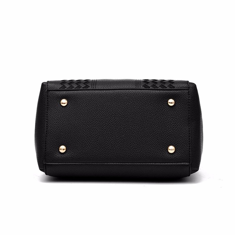 Bottom view of black Darling Pom Pom handbag showing structured base and four protective gold tone metal feet