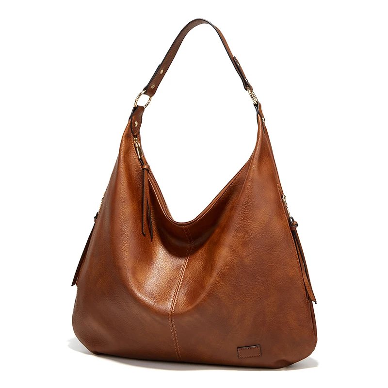 Angled front view of brown Delaney Large Hobo Bag featuring textured leather-look material, curved opening, gold-tone rings and oversized design