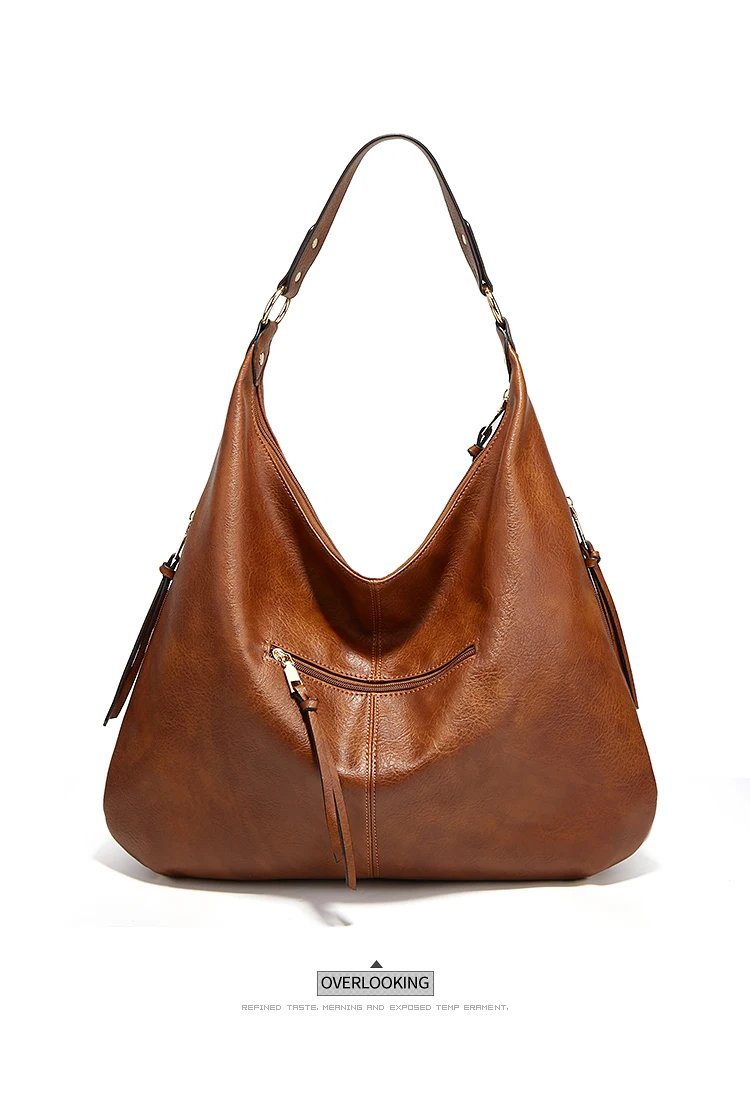 Reverse view of brown Delaney Large Hobo Bag featuring a horizontal zippered pocket, decorative zipper pull, curved opening and gold-tone hardware