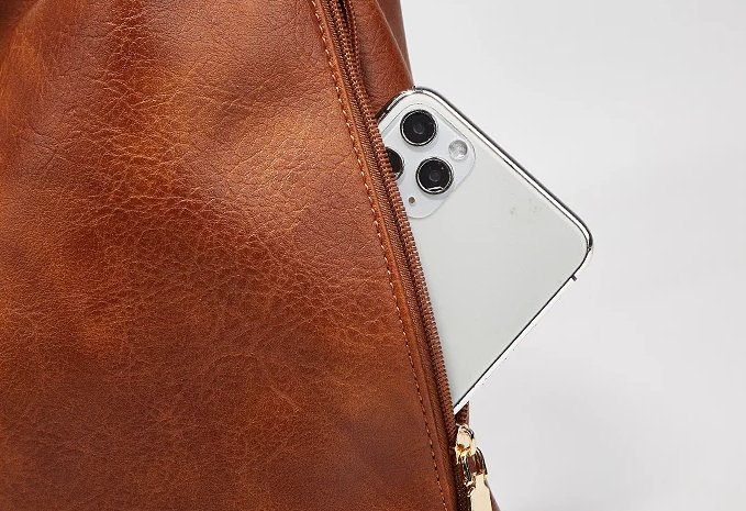 Close-up of brown Delaney Large Hobo Bag showing a smartphone partially inserted into the side zipper pocket and detailed textured material