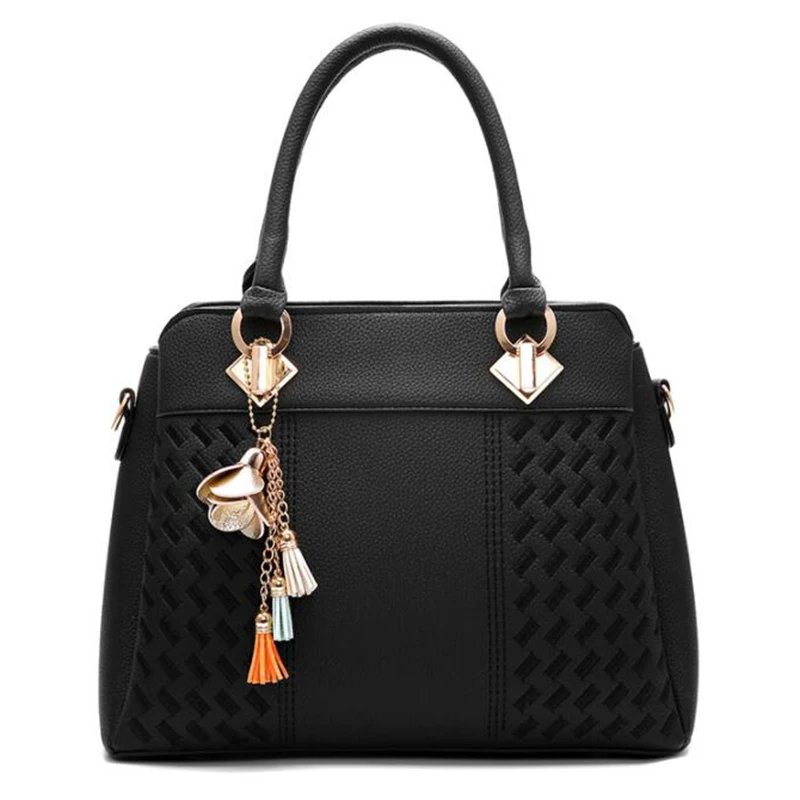 Front view of black Delphine Tassel Charm handbag with textured woven panels, double top handles and decorative flower tassel charm