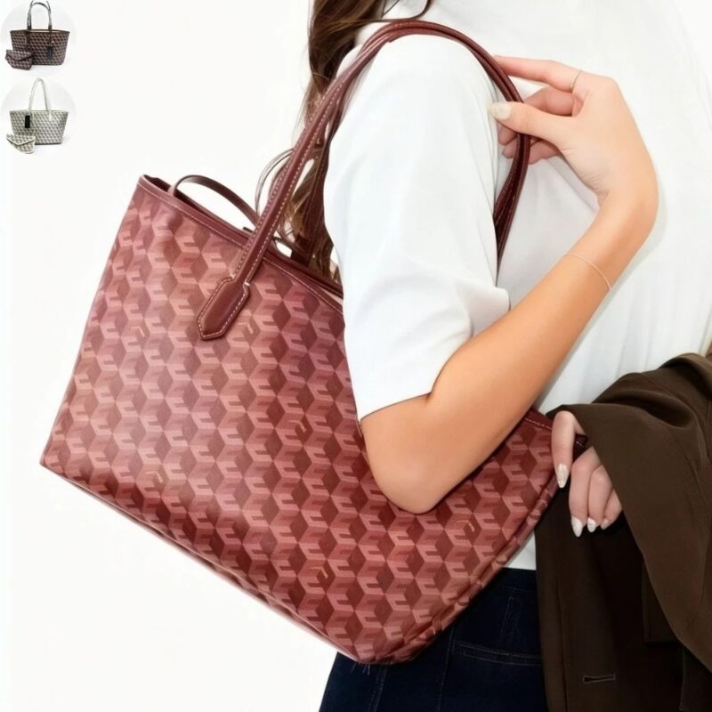 Woman carrying burgundy Ellery Geometric Print Tote Bag with long shoulder handles, spacious trapezoid shape and allover geometric pattern