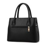 Back view of black textured satchel handbag with double handles, exterior zip pocket and gold-tone zip pull