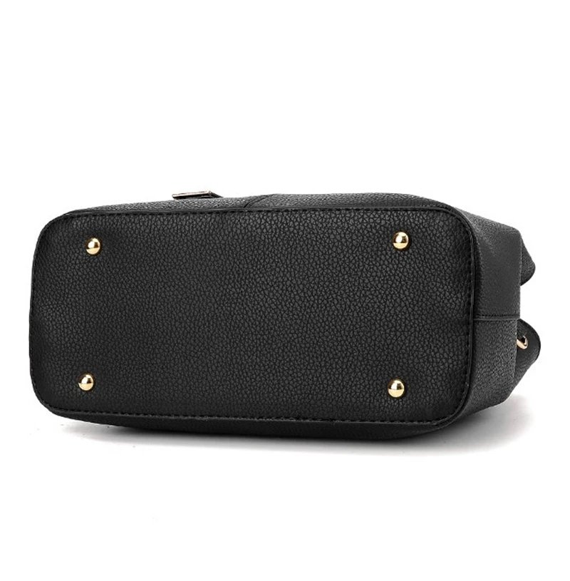 Bottom view of black textured satchel handbag with structured base and four protective metal feet