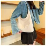 Beige Hollis Slouchy Tote Bag worn over the shoulder with relaxed oversized shape, soft finish and adjustable strap