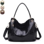 Mamba Snake Embossed Hobo Bag (1) Black snake embossed hobo bag for women with double handles, adjustable shoulder strap, tassel charm, and gold tone hardware