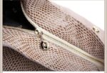 Mamba Snake Embossed Hobo Bag-beige (5) Close-up of beige snake embossed women’s hobo bag showing exterior zipper pocket, textured finish, and gold tone zipper hardware