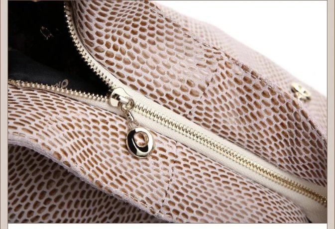 Close-up of beige snake embossed women’s hobo bag showing exterior zipper pocket, textured finish, and gold tone zipper hardware