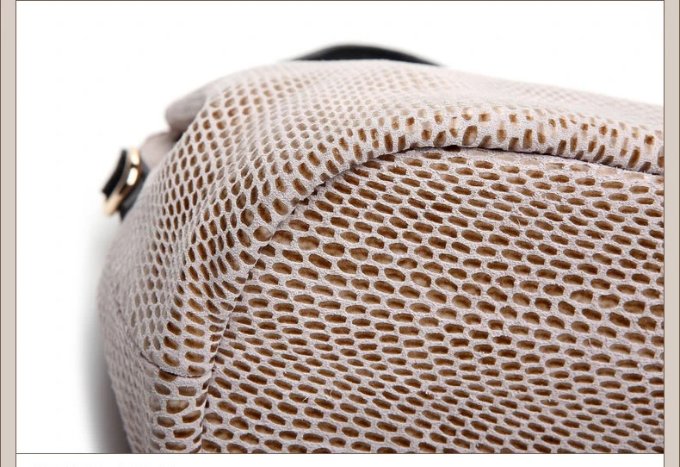 Close-up of beige snake embossed hobo handbag base showing reinforced stitching and textured snake pattern construction