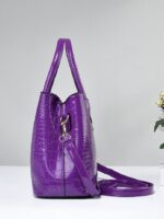 Side view of purple Marlow croc embossed satchel bag showing structured depth and detachable crossbody strap