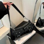 Quinn Double Pocket Shoulder Bag-black (3) Black Quinn Double Pocket Shoulder Bag displayed with adjustable shoulder strap, twin buckle pockets, top zip closure and silver hardware
