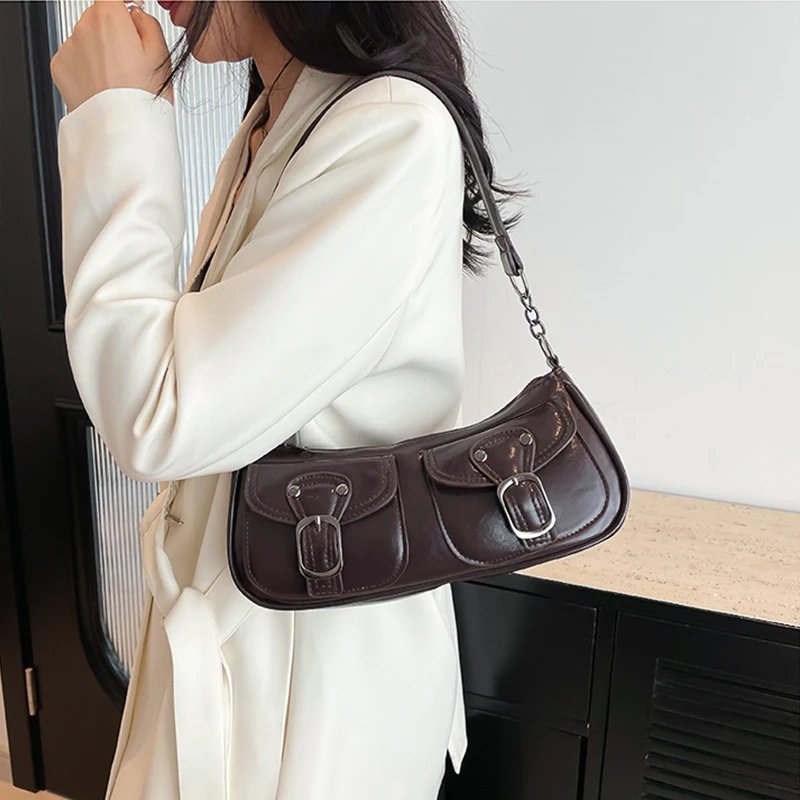 Coffee brown Quinn Double Pocket Shoulder Bag worn on the shoulder with twin buckle pockets, silver hardware and glossy finish