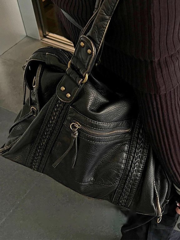 Reese Vintage Washed Shoulder Bag (1) Black Reese Vintage Washed Shoulder Bag with distressed leather-look texture, braided detailing, gold-tone hardware and front zipper pocket worn over the shoulder