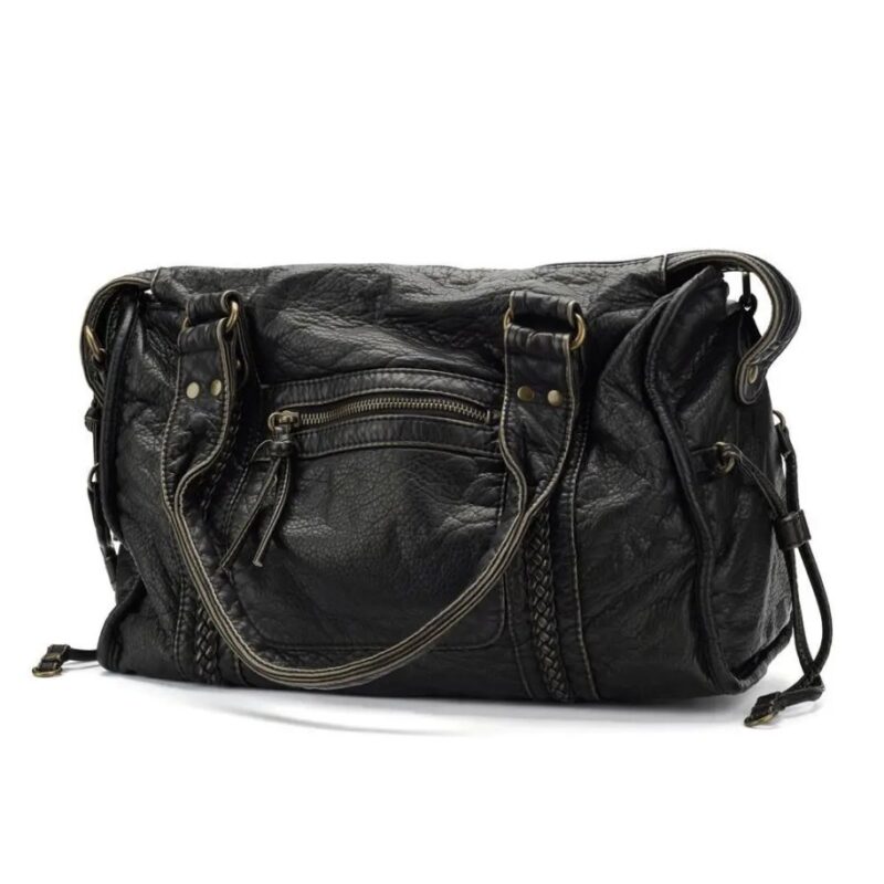 Front view of black Reese Vintage Washed Shoulder Bag featuring slouchy silhouette, braided vertical panels, front zipper pocket and double carry handles