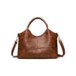 Rowan Retro Crossbody Bag-brown (6) Front view of brown Rowan retro crossbody handbag with top handles, shoulder strap and stitched panel design