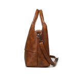 Rowan Retro Crossbody Bag-brown (7) Side view of brown Rowan retro crossbody bag showing structured depth, top handles and detachable strap
