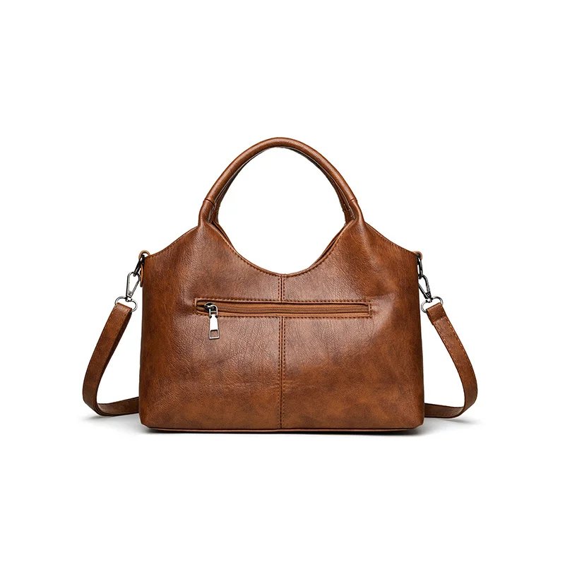 Back view of brown Rowan retro crossbody bag with exterior zip pocket and detachable shoulder strap