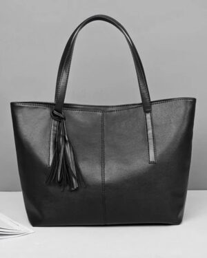 Sable black tassel tote bag with long double shoulder handles, smooth finish and spacious structured design