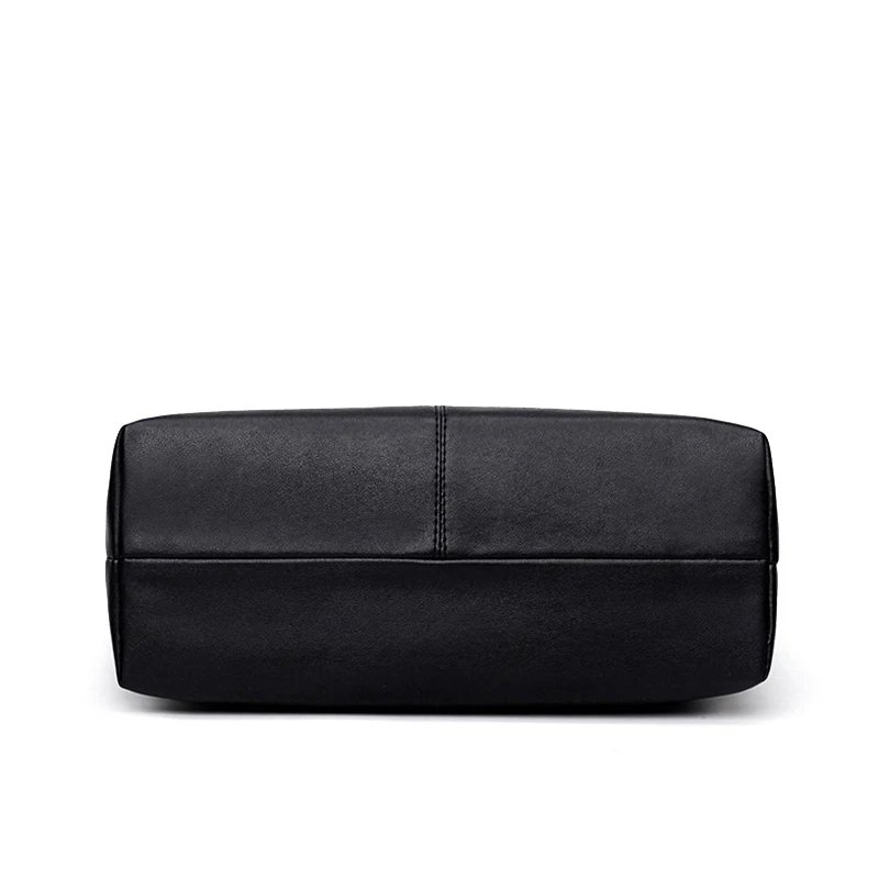 Bottom view of Sable black tassel tote bag showing wide flat base and reinforced centre stitching