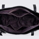 Interior view of Sable black tassel tote bag showing spacious lined compartment with internal zip and slip pockets