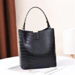 Sienna Croc Pattern Bucket Bag-black (2) Front view of black Sienna croc pattern bucket handbag with structured shape, top handle and gold tone clasp