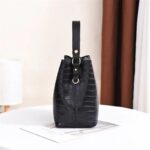 Sienna Croc Pattern Bucket Bag-black (4) Side view of black Sienna croc pattern bucket bag showing structured base, top handle and shoulder strap ring