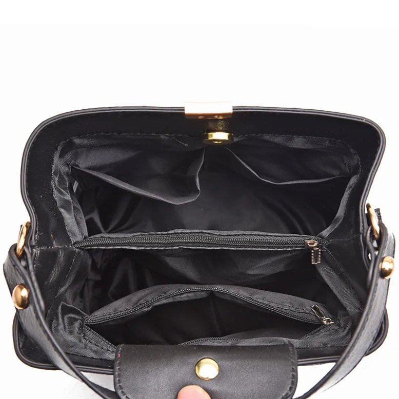 Interior view of black Sienna croc pattern bucket bag showing lined compartments, zip pockets and internal storage