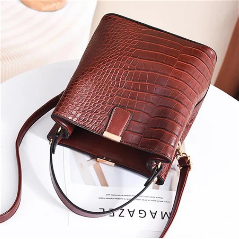 Top view of dark brown Sienna croc pattern bucket bag showing textured exterior, top handle and shoulder strap