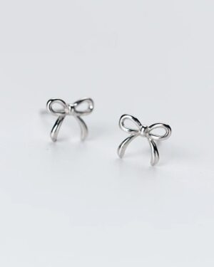 Vivienne sterling silver bow stud earrings with a delicate polished ribbon design and minimalist feminine style